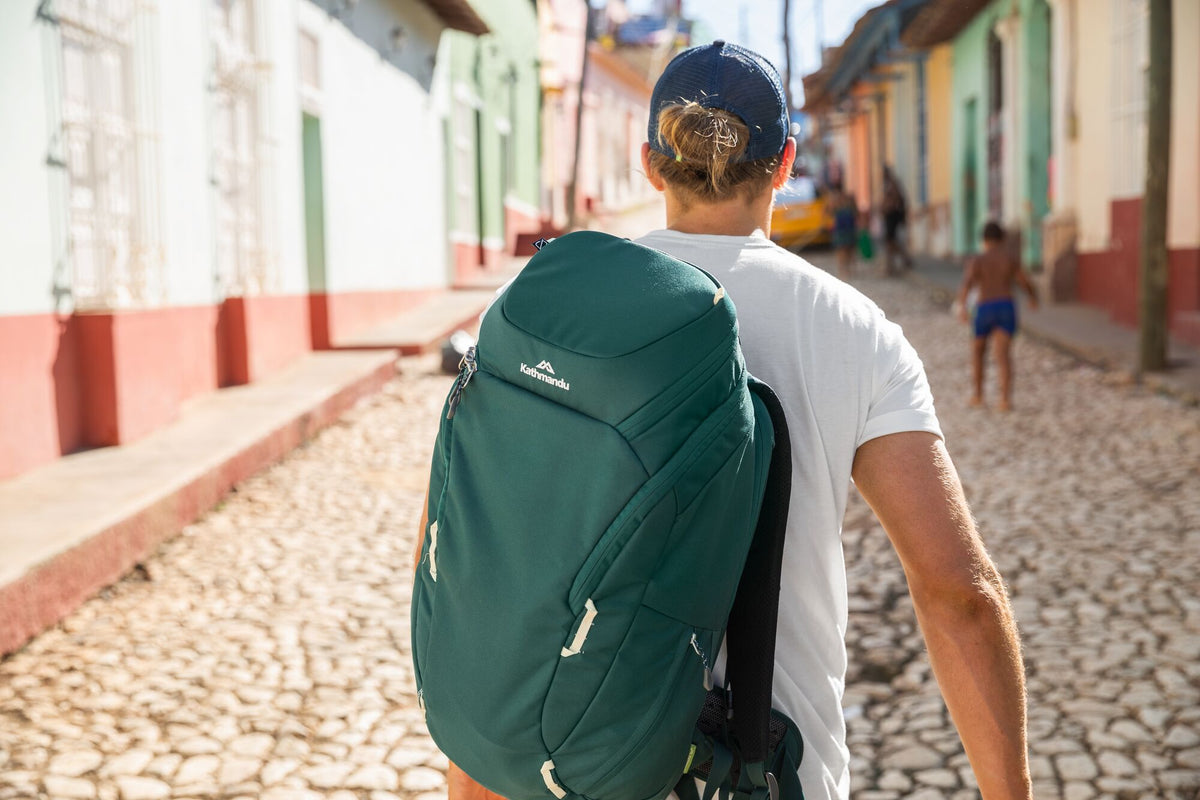 A man is carrying a Kathmandu day pack through the streets of Cuba.